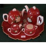 A mid-20th century ceramic tea set on conforming tray, comprising: teapot, coffee pot,