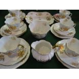 An early 20th century Shelley part-tea service in the 'Flowers of Gold' pattern, no. 14187,