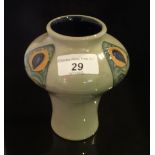 A Moorcroft vase, with stylized floral decoration on a bulbous body over tapering base,