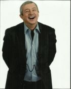 Louie Walsh the X-Factor judge signed laughing 10 x 8 colour 3/4 length portrait photo. Good
