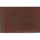 1960s Motor Racing Drivers. Small Brown hardback autograph album with 20+ autographs obtained at