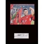 Steven Gerrard. Signature with famous shot holding the European Cup. Professionally mounted in black