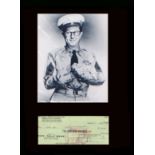 Phil Silvers. Signed cheque with a picture as ‘Sgt Bilko.’ Professionally mounted in black to 16”
