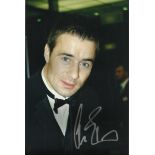 Linus Roache signed colour 12x8 photo. Good condition