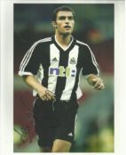 Aaron Hughes in Newcastle strip signed colour 10x8 photo. Good condition