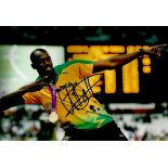Usain Bolt signed 12 x 8 colour photo signed at the Commonwealth Games 2014. Good condition