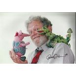 Peter Firmin signed 12 x 8 colour photo with Clangers puppets on his shoulder. Good condition