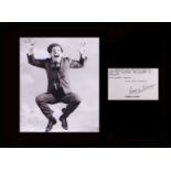 Sir Norman Wisdom. Typed letter signed with classic picture. Professionally mounted in black to 16”