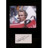 Niki Lauda. Signature with picture in Formula 1 car. Professionally mounted in black to 16”x12”.