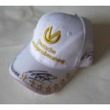 Michael Schumacher A full size adult cap clearly signed by Michael Schumacher in black marker on the