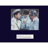 Sir Norman Wisdom. Signature with classic photo. Professionally mounted in navy to 10”x12”.