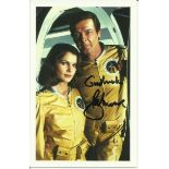 Roger Moore signed colour 6x4 James Bond postcard. Seen here alongside Los Chiles. Good condition