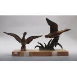An Art Deco bronzed spelter of duck alighting, on a marble plinth