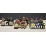 Britains and other: eleven seated figures, and three Britains green park benches, and one other