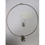 An Italian snake link chain and two diamond set seahorse pendants, all of white precious metal,