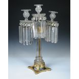 A 19th century ormolu and glass lustre candelabrum, the three cut glass nozzles above bead and