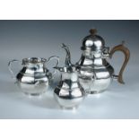 A George I style silver three piece tea set, by Thomas Bradbury & Son, London 1929, comprising: a