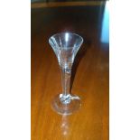An 18th century wine glass with teared stem and trumpet bowl on circular foot, 17cm (6.75 in) high