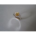 A yellow sapphire and diamond three stone ring set in 18ct gold, the oval cut deep yellow sapphire