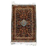 A small Kashmir silk rug, India, decorated with floral designs on a black ground 100 x 64cm (39 x