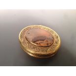 A 19th century agate set gilt white metal snuff box the hinged oval lid engraved with foliage, birds