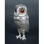 A small silver cayenne pot by Richard Comyns, London 1977, modelled as an owl with coloured glass