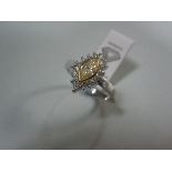 A certificated marquise cut yellow diamond and diamond cluster ring, the fancy light yellow marquise