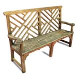 A Lutyens style teak garden bench, with lattice back 106 x 167 x 46cm (41 x 65 x 18in) Weathering