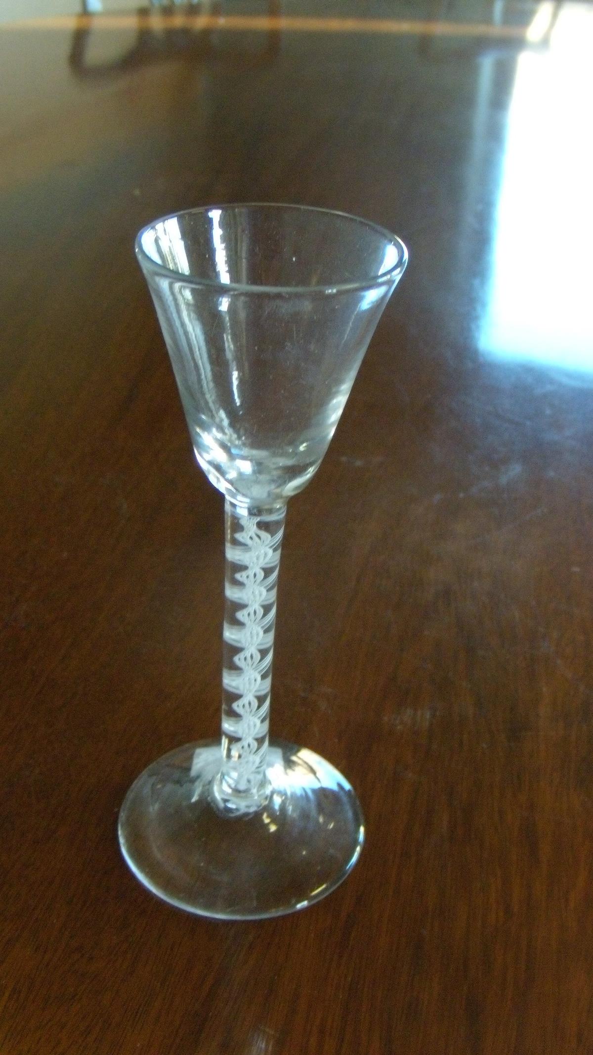An 18th century opaque twist wine glass, the conical bowl on double helix stem and circular foot,