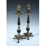 A pair of Regency gilt candlesticks, the spiral fluted baluster columns raised on lion paw feet,