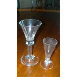 An 18th century wine together with a fluted ale, the first with bell bowl and clear stem, 18.5cm (