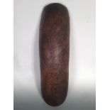 An Aboriginal wood coolomon, the arched side of the carrying vessel carved with snakes and flower