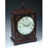 A Regency mahogany bracket clock, the gadrooned cornice above circular enamel dial marked '