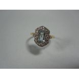 An Art Deco aquamarine and diamond ring, set with an emerald cut aquamarine in a rectangular