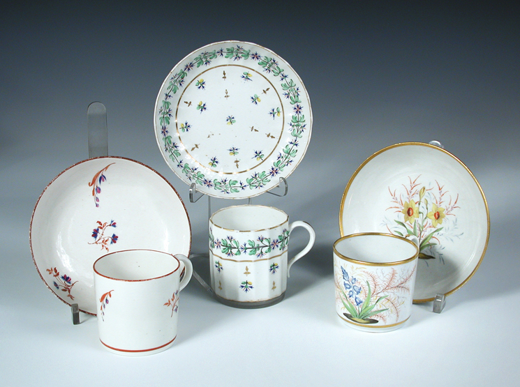 Attributed to Pinxton, three coffee cans and saucers, one painted with a 'Hyacinth' and a 'Jonquil',