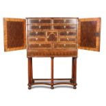 A Queen Anne style laburnum oyster veneer cabinet, 19th century fitted small drawers and central