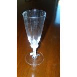 An 18th century opaque twist wine glass, the tall rounded conical bowl directly above a bun knop,