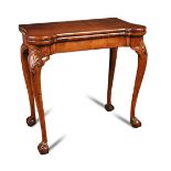 A George I walnut card table, with shaped fold over top and on shell carved knees and on ball and