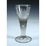 An 18th century soda glass, the trumpet bowl engraved with a couple walking between trees, a tear at