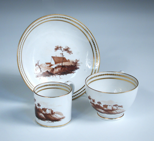 Attributed to Chamberlain's Worcester, a miniature trio of tea cup, coffee can and saucer, each