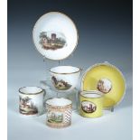 A Coalport trio, a can and saucer and a single can, the first painted with ruins in a landscape, the