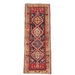 A Shirvan runner, decorated with four hooked medallions to a yellow border 277 x 100cm (108 x 39in)