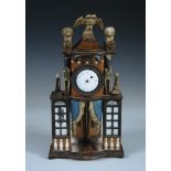A miniature Empire style polychrome decorated 'commode' clock, the case surmounted by a double