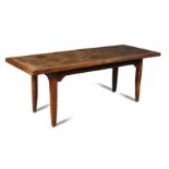 An 18th century fruitwood farmhouse table, the single plank top with a cleated border on square