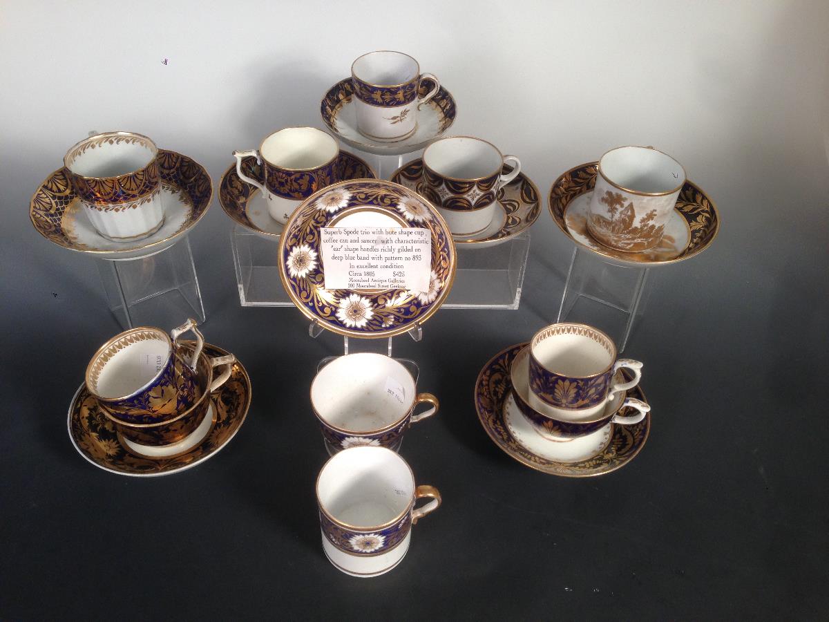 Eight early 19th century coffee cans and saucers, some with additional cups, all decorated with blue