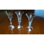 Three 18th century wine glasses, one with a tear at the base of the bell bowl above a disc knop,