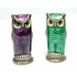 A pair of Norwegian metalwares pepper casters, each modelled as an owl, one with green enamel