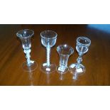 Four 18th century wine glasses and a flute, the soda glass with opaque twist stem, 14.5cm (5.75