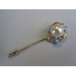 A pearl and diamond set stick pin / brooch, set with an 11.2mm pearl to a pierced bi-coloured