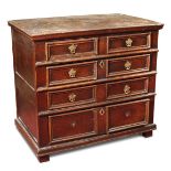 A Charles II oak chest, fitted four long drawers with moulded panel drawer fronts, brass drop